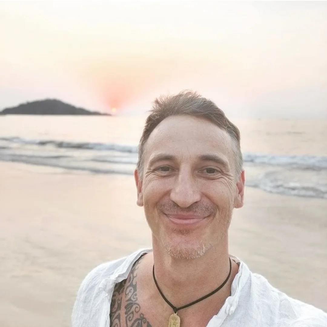 Jarek, founder of HeyFrom.me, on a beach at sunset
